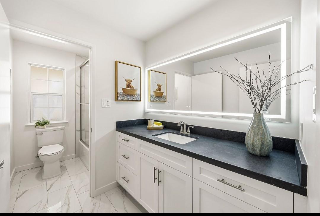 Renovated interior with painted walls, long vanity and tub