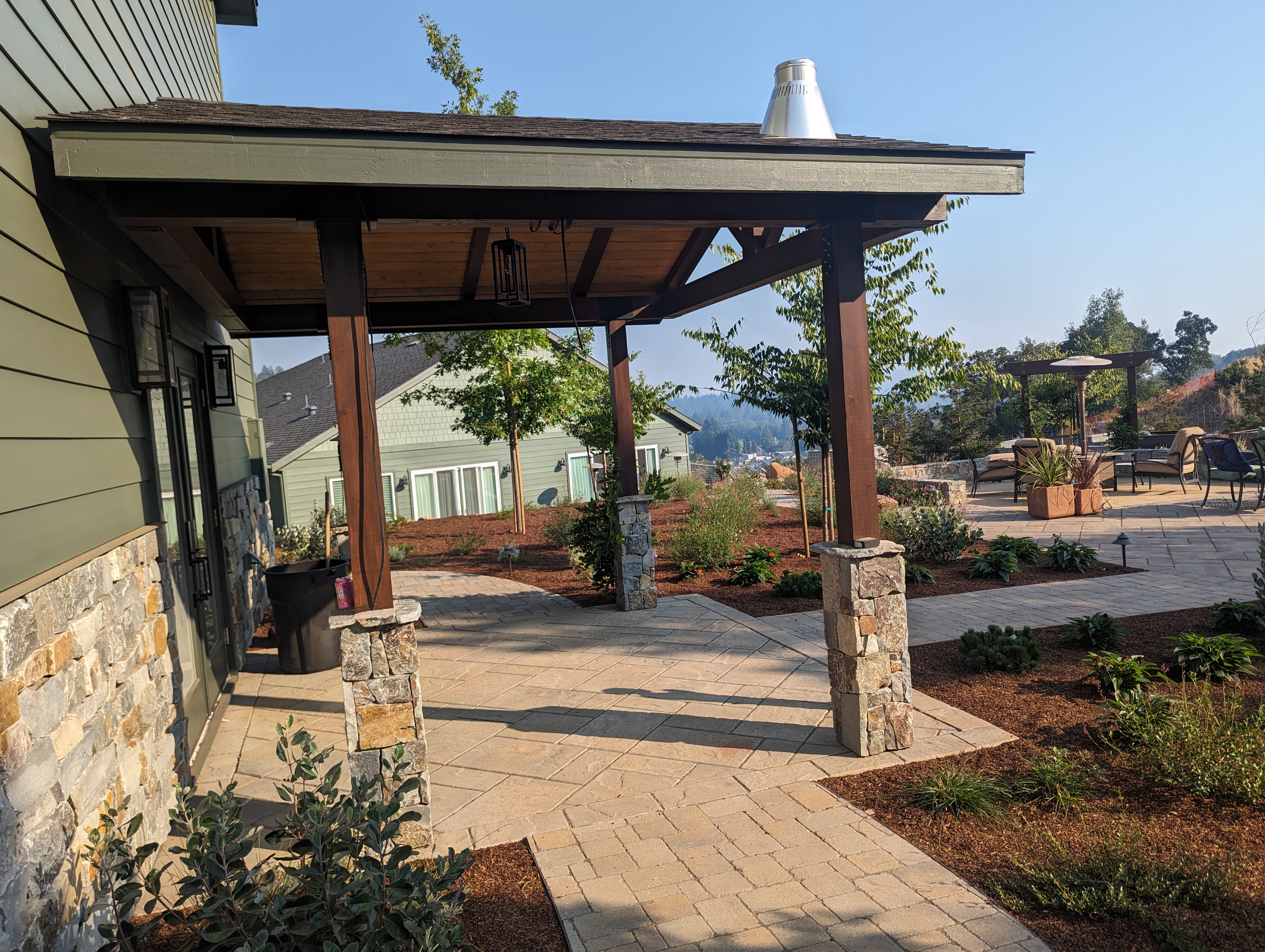 Covered patio with stained timber posts on stone columns built by QBR